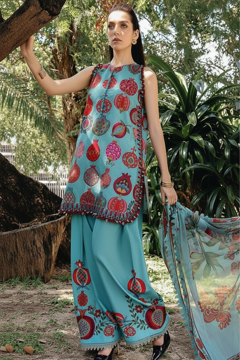 A fashion catalog page showing a woman outdoors wearing a printed sleeveless tunic and matching pants in turquoise blue with red and pink pomegranate motifs. Smaller inset photos of the same outfit appear on the right, alongside the text 'M.