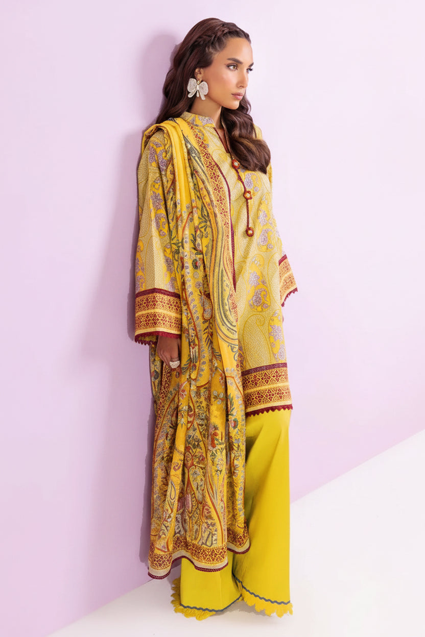 A model wearing a yellow and gold digital print three-piece traditional outfit from Bonanza Satrani's 'Bohemian Vibe' collection, shown against a light pink background with product details on the right.