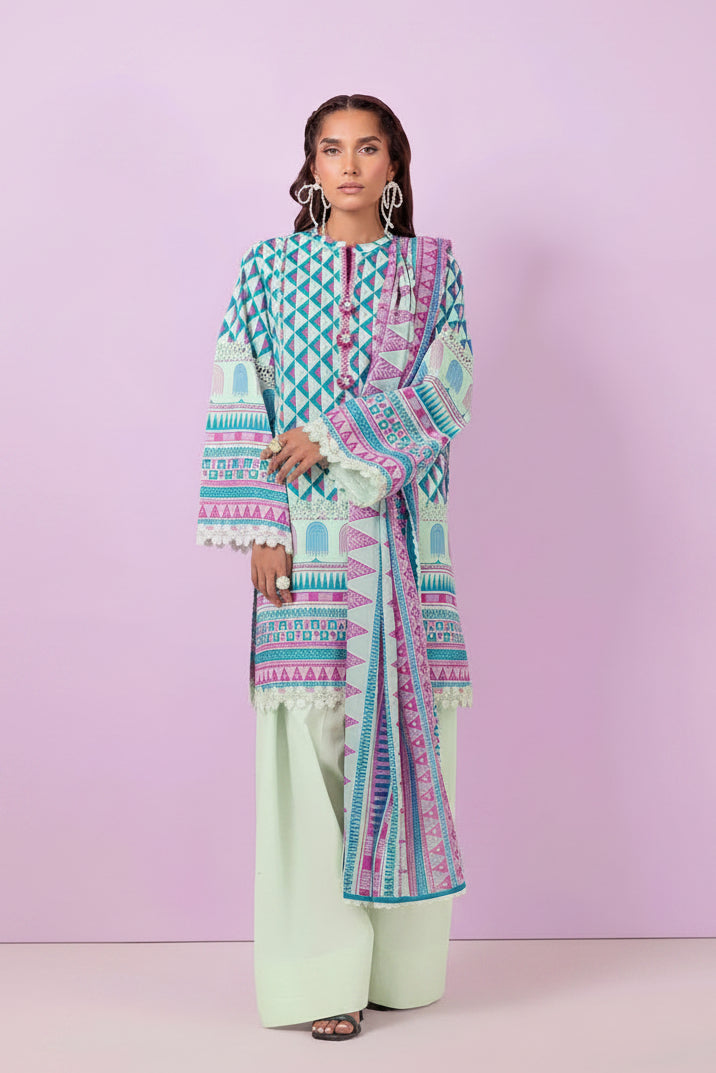 A model wearing a Bonanza Satrani 'Bohemian Vibe' unstitched collection 03-piece outfit. The set includes a multicolor geometric patterned shirt in blue, pink, and green, paired with a matching printed dupatta and light green wide-leg trousers.