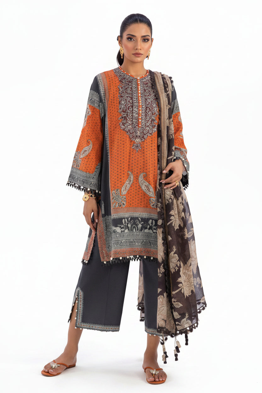 Sana Safinaz Classic-26 three-piece women's suit set featuring a printed kurta in orange, black, and beige with a matching dupatta, shown on a model against a light lavender background with product details at the bottom.