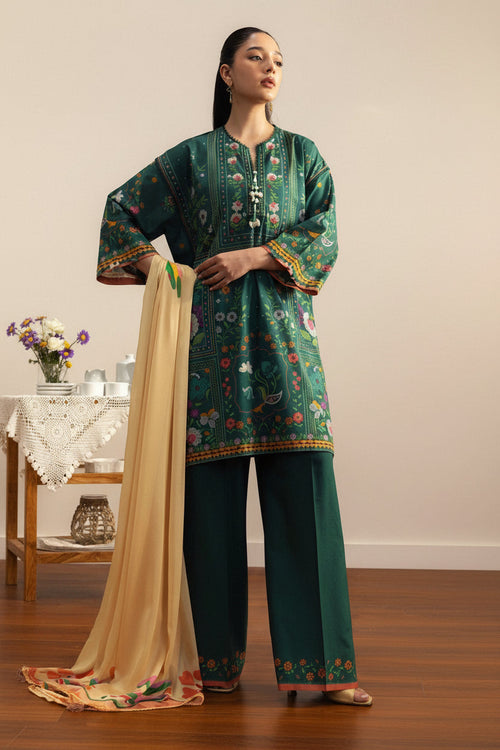 A fashion catalog page showing a woman modeling a green printed kurta set with a beige dupatta, alongside product text for 'COCO BY ZARA SHAHJAHAN PRINTS' and care instructions.