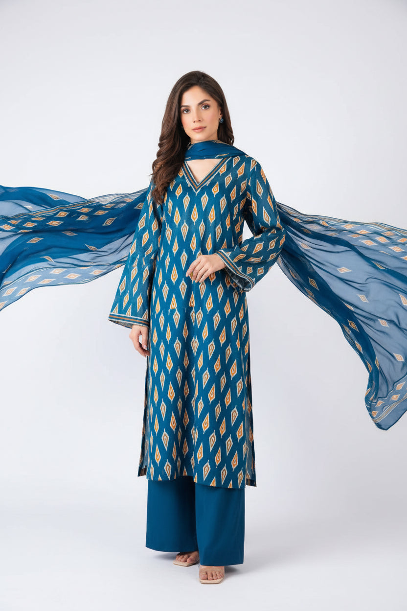 A catalog page for Bareezé Lawn Premium Collection showing a woman modeling a blue and gold patterned unstitched 3-piece set, including a long kurta, printed lawn shirt, and printed vogue dupatta. The page includes product text, care instructions, and a barcode on a white background.