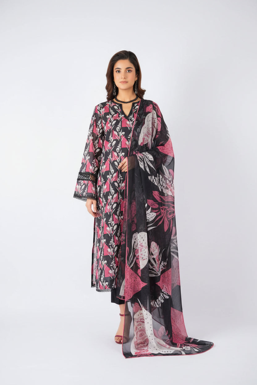 A model wearing a Bareezé 3-piece unstitched lawn collection set, featuring a digital printed lawn shirt, digital printed voile dupatta, and cambric dyed trouser. The set has a black base with pink and green floral patterns.