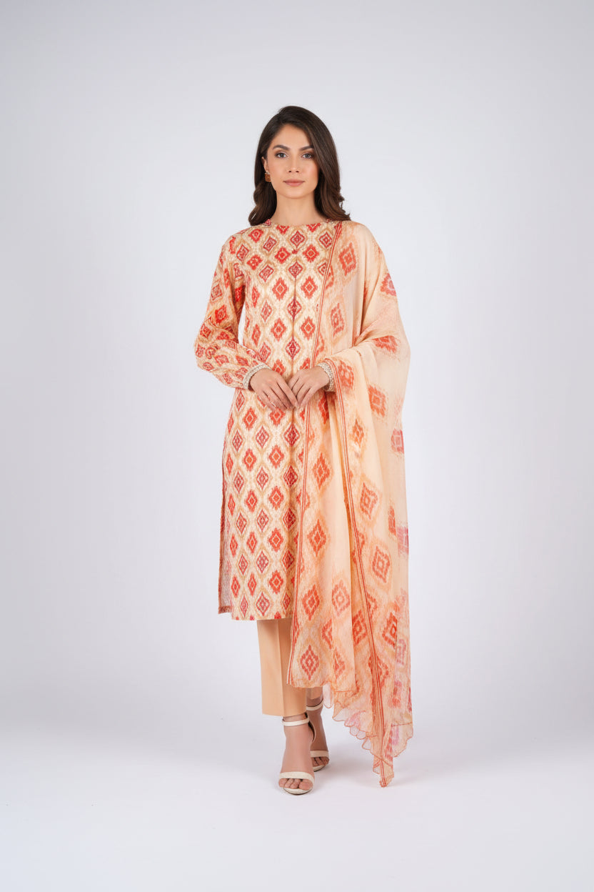 A fashion catalog page for Bareezé Lawn Premium Collection showing a woman modeling a peach and orange printed three-piece outfit, including a kurta, trousers, and dupatta, alongside smaller inset views and product text details.